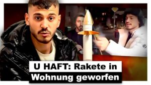 Video thumbnail showing a surprised influencer with wide eyes and open mouth, holding a toy rocket in a living room setting. The background features a blurred image of police officers entering the room. Text overlay reads, "Influencer schießt R4KETE in fremde Wohnung, wird VERH4FTET & beschwert sich über Deutschland" in bold letters.