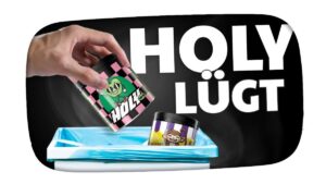 A thumbnail for the video "HOLY HAT UNS ALLE BELOGEN! - Kuchen Talks #1045" from the channel KuchenTV, featuring a surprised-looking KuchenTV with a colorful background, bold text overlay, and expressive graphics.